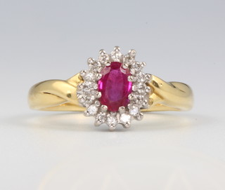 An 18ct yellow gold oval ruby and diamond cluster ring size O 