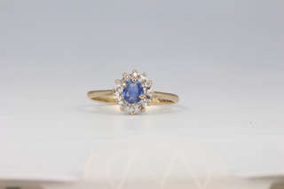 A 9ct yellow gold oval sapphire and diamond cluster ring, the centre stone approx 0.4ct 