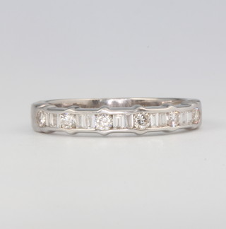 An 18ct white gold brilliant and baguette cut half eternity ring size O 