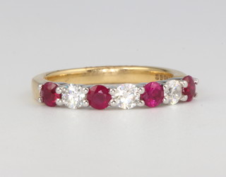 An 18ct yellow gold 4 stone ruby and 3 stone diamond ring, the rubies 0.4ct, the diamonds 0.45ct, size M 