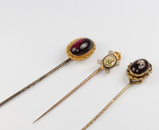A yellow gold diamond set cabochon garnet tie pin and 2 others 