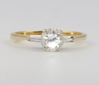 An 18ct yellow gold single diamond ring approx. 1.25ct, flanked by tapered baguettes, size V 1/2