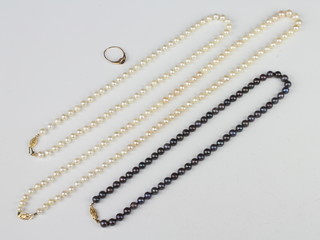 A string of cultured pearls with 14ct yellow gold clasp 66cm, a smaller string 46cm and a black coloured ditto 46cm together with a small sapphire ring 