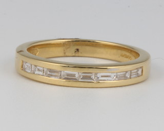 An 18ct yellow gold baguette cut diamond ring size L 