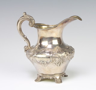 A Victorian repousse silver cream jug with engraved cartouche on scroll feet London 1839, 210 grams 