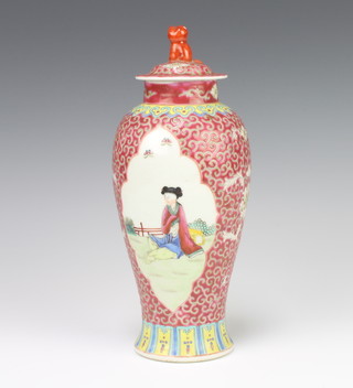 A 20th Century Chinese red ground oviform vase decorated with panels of figures 24cm 