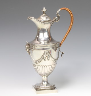 A Georgian silver ewer of Adam design with satire mask and chased armorial, gross 885 grams 30cm  
