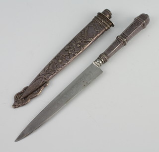 A Continental silver handled knife, the steel blade etched Guacha, contained in a repousse silver floral decorated scabbard 28cm 