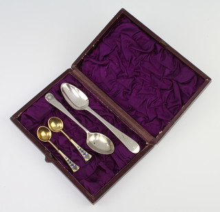 A pair of Russian silver gilt and enamelled salt spoons and 2 other spoons