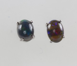 A pair of black opal ear studs 