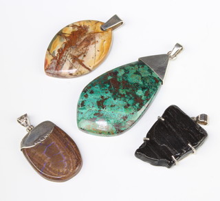 Four silver mounted hardstone pendants 