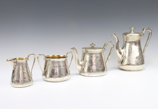 A Victorian matched 4 piece silver tea and coffee set with chased flowers and geometric decoration, some having monograms and armorials, gross 1861 grams, dates London 1868, 1881 and 1883, the teapot, sugar bowl and cream jug maker Walter and John Bunnard, the coffee pot a different maker with rubbed marks