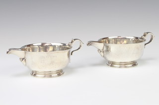 A pair of circular silver sauce boats with S scroll handles, 526 grams, London 1935, maker Shapland 