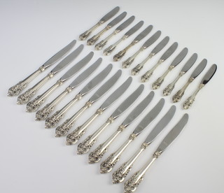 Twelve Continental silver handled dinner knives and 12 ditto butter knives with fancy Rococo handles 