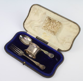 A cased christening set comprising fork, spoon and napkin ring, London 1910, 79 grams