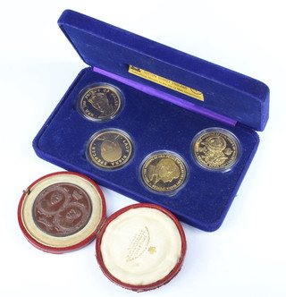 A cased set of 4 Pobjoy mint silver gilt commemorative crowns each 28 grams and a bronze commemorative coin 