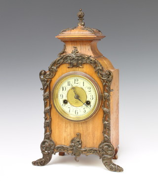 A Hamberg American Clock Company 19th Century striking mantel clock contained in a walnut finished case with enamelled dial and Arabic numerals contained in a walnut and gilt mounted case 