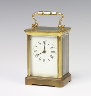 A 19th Century French 8 day carriage timepiece with enamelled dial and Roman numerals contained in a gilt metal case 