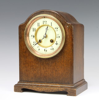 Japy Freres, a French 8 day striking mantel clock with enamelled dial and Arabic numerals contained in an oak arch shaped case, the back plate numbered 100748, complete with pendulum and key 