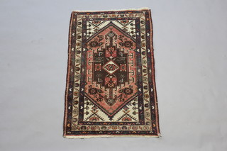 A red, white and blue ground Turkey rug with central medallion 117cm x 78cm 