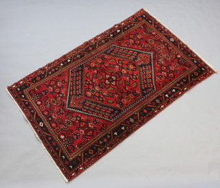 A red and blue ground Afghan rug with diamond shaped medallion within a multi row  border (in wear) 202cm x 125cm 