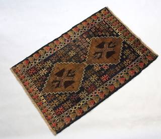 A black and brown ground Belouche rug with 2 diamond medallions to the centre 125cm x 84cm 