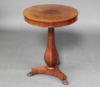 A William IV circular mahogany wine table raised on a baluster turned column with triform base and paw feet 68cm x 50cm 