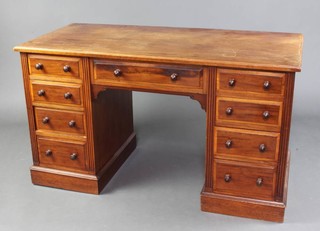 A Victorian walnut pedestal dressing table/desk fitted 1 long and 8 short drawers with tore handles and fluted decoration to the sides 74cm h x 129cm w x 60cm d  (this desk is in one section) 