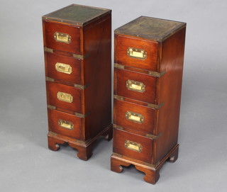 A pair of military style pedestal chests with inset tooled leather tops, brass mounts, fitted 4 long drawers raised on bracket feet 69cm x 22cm x 25cm 
