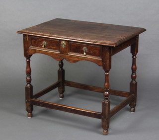 An 18th Century oak side table fitted a drawer raised on turned and block supports 72cm h x 83cm w x 49cm d 