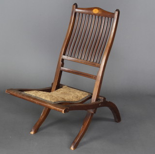 An Edwardian inlaid mahogany stick and rail back folding campaign chair 