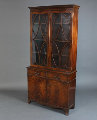 A Georgian style mahogany display cabinet on cabinet with moulded cornice, the upper section fitted shelves enclosed by astragal glazed panelled doors, the base fitted 2 drawers with brass swan neck handles above a double cupboard, raised on splayed bracket feet 191cm h x 92cm w x 33cm d 