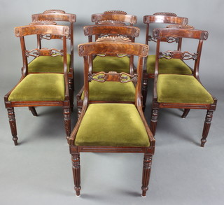 A set of 7 William IV mahogany bar back dining chairs with pierced mid rails and drop in seats raised on turned and fluted supports 