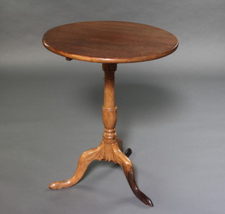 A 18th Century circular bleach oak snap top wine table raised on a pillar and tripod base 70cm x 54cm 

