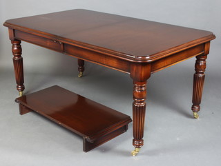 A Victorian style mahogany dining suite comprising rectangular dining table with 1 extra leaf, raised on turned and reeded supports ending in brass caps and casters 78cm h x 100cm w x 168cm l x 214 cml l when extended, together with 6  mahogany balloon back dining chairs with carved mid rails and over stuffed seats raised on turned and fluted supports 
