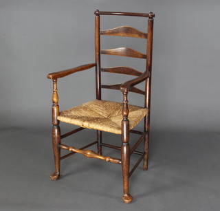 An 18th Century elm ladder back carver chair with woven rush seat raised on club supports 