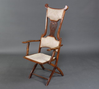 An Edwardian Art Nouveau mahogany folding campaign armchair 