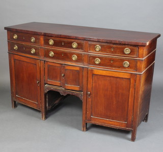 A Georgian mahogany bow front sideboard fitted 6 short drawers above a pair of cupboards flanked by cupboards with brass ring drop handles 95cm x 155cm x 61cm 