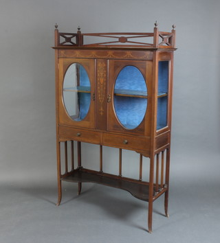 An Edwardian inlaid mahogany display cabinet with pierced 3/4 gallery, fitted shelves enclosed by glazed panelled doors, the base fitted 2 long drawers with undertier, raised on outswept supports 174cm h x 107cm w x 39cm d 