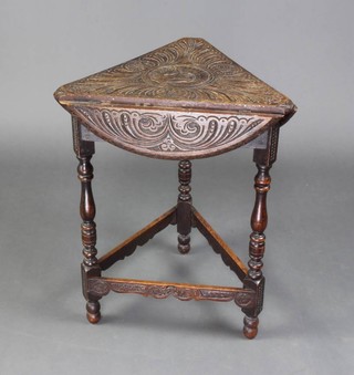 A Victorian carved oak drop flap cricket table, carved and a dragon,  raised on turned and block supports 60cm x 47cm x 43cm x 57cm when open 