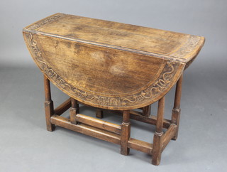 An 18th Century carved oak drop flap gateleg dining table fitted a frieze drawer, raised on turned and block supports, top carved "It is more blessed to give than to receive" 71cm h x 103cm w x 37cm x 117cm when open  