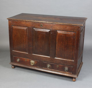 An 18th Century dark oak mule chest with hinged lid and panelled decoration to the front, the base fitted 2 drawers raised on bracket feet 90cm h x 120cm w x 52cm d 
