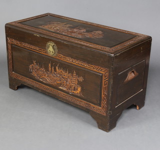 A Chinese carved camphor coffer with hinged lid, raised on bracket feet 57cm h x 103cm w x 50cm d 