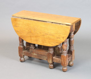 A 17th Century style oak oval drop flap gateleg tea table 48cm x 62cm x 23cm (some slight scratches to the top) 
