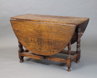 An 18th Century oak drop flap gateleg dining table raised on turned supports 70cm x 112cm  x 47cm (old split to top) 