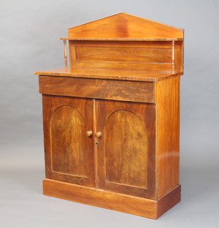 A Regency mahogany chiffonier with raised back, fitted a drawer above arched panelled doors, raised on a platform base 128cm h x 92cm w x 41cm d (some signs of old but treated worm) 