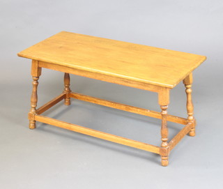 A rectangular light oak occasional table on turned and block supports 46cm h x 89cm w x 43cm d 