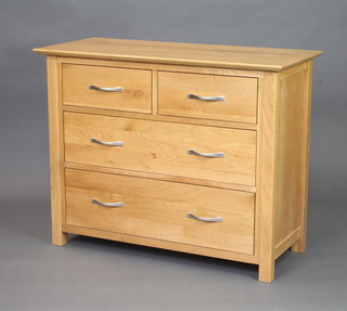 A light oak chest of 2 short and 2 long drawers with shaped chrome handles 77cm x 98cm x 42cm 