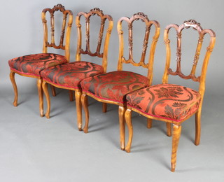 A set of 4 Victorian mahogany hoop back dining chairs, the seats of serpentine outline, raised on cabriole supports (frames slightly loose) 