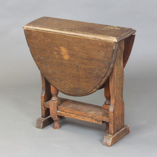 A 1930's oak oval drop flap gateleg tea table 60cm x 60cm x 23cm (some light staining in places) 